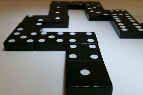 Domino. The Thai for "domino" is "โดมิโน".